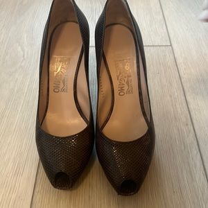 Worn Ferragamo python pumps.